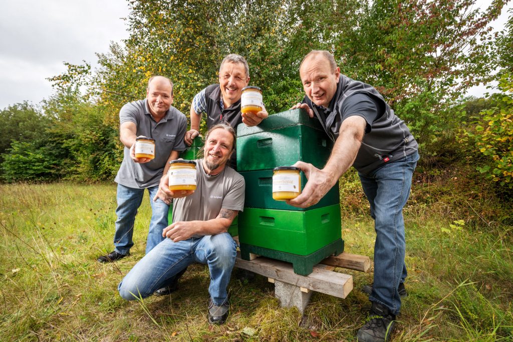 burgbad staff and beekeepers present the homegrown honey